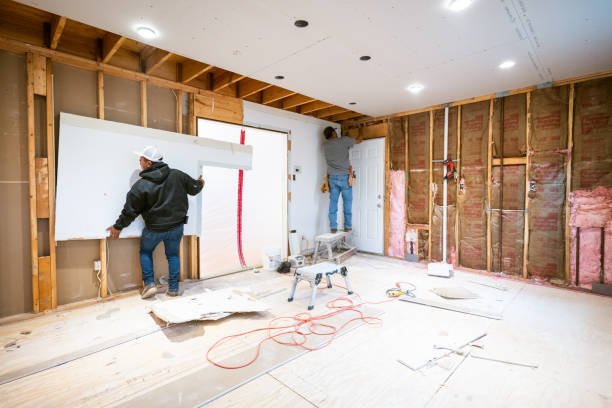 Drywall installers working in an old kitchen renovation